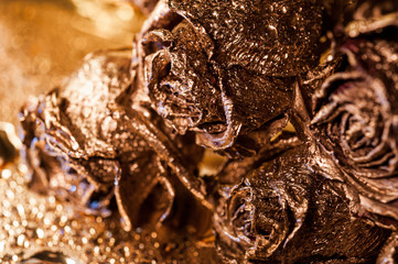 Abstract macro fine-art background with golden roses and water drops. Symbol of love, wealth, rich.