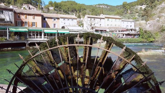 Fontaine-De-Vaucluse, small village in Provence, France with river. Summer holidays, landscape, French nature, water wheel