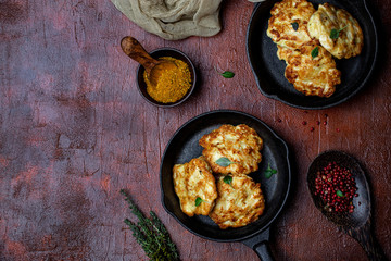 chicken cutlets with cheese on a cast iron pan