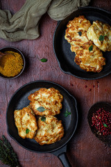 chicken cutlets with cheese on a cast iron pan