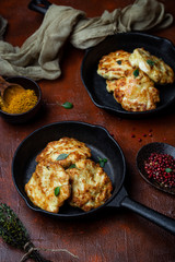 chicken cutlets with cheese on a cast iron pan