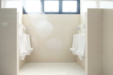 Urinals in public toilet with sun light
