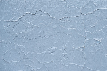 Blue board with cracks from paint. Old wall background.