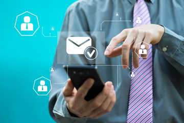 Businessman presses button email web on phone virtual electronic user interface.