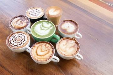 Coffee cup with Green Matcha latte art foam on wood table in coffee shop with copy space.Coffee is one of the most popular beverages.Improve Energy Levels and Burn Fat