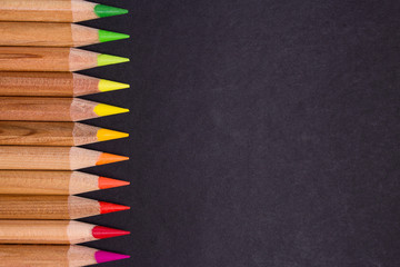 Colorful pencils on black background
