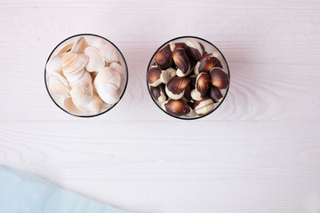 Seashell and chocolate sweets on wooden background 
