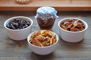 Various dried fruit displayed on an old wooden table.
