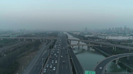Aerial top view of highway interchange on the sunset. Aerial top view of road junction from above, automobile traffic and jam of many cars, useful for engineering, industrial, transportation concept