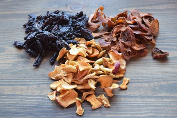 Various dried fruit displayed on an old wooden table.