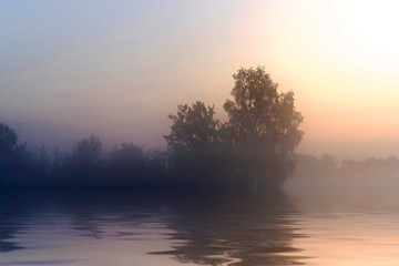 Rural early morning sunrise with lake, fog and russians landscape.