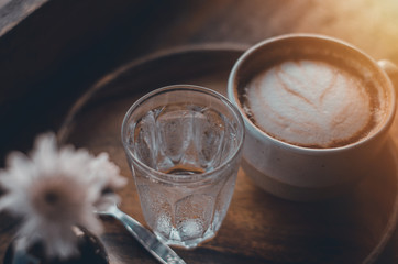 Coffee with smoke floating over the cup Fragrant in the morning.Coffee cup on the table in the cafe.Do not focus on objects.