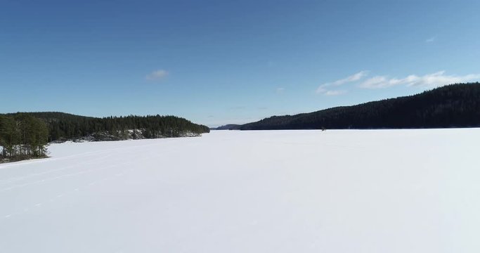 Aerial footage of beautiful winter lake covere by snow