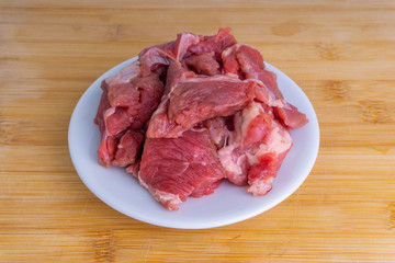 Fresh raw beef steak on wooden background with selective focus