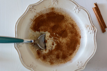 Oatmeal with cinnamon in a vintage bowl and a spoon