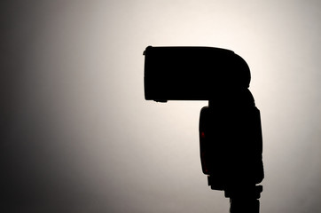 Silhouette digital camera flash over gradient background
