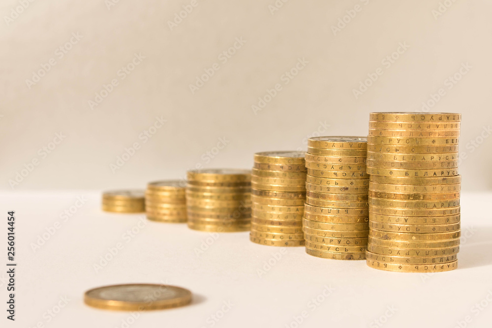 Wall mural stacks of coins on a light background. business concept and growth of capital.