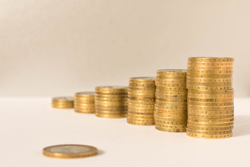 Stacks of coins on a light background. Business concept and growth of capital.
