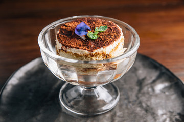 Tiramisu in glass cup is a coffee-flavoured Italian dessert. It is made of ladyfingers dipped in coffee, layered with a whipped mixture of eggs, sugar, and mascarpone cheese, flavoured with cocoa.