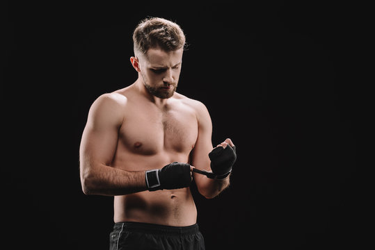 Strong Muscular Mma Fighter Fixing Bandages Isolated On Black