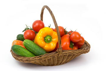 basket with fresh vegetables on white background