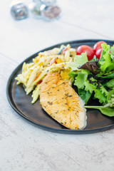 close-up of plate of pasta and chicken with lettuce