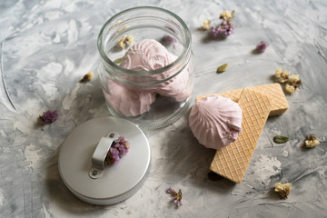 A waffles and marshmallows on a gray background,small flowers. flat lay
