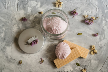 A waffles and marshmallows on a gray background,small flowers. flat lay