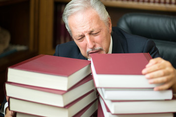 Desperate man surrounded by books