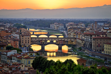 Fototapeta na wymiar Florence cityscape and Arno river bridges sunset view