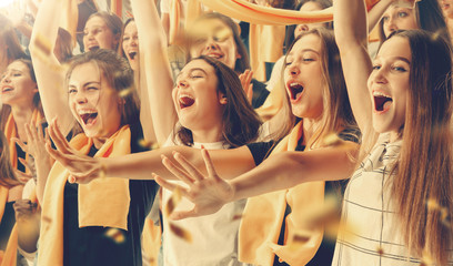 Group of happy fans are cheering for their team victory.