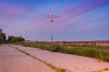 Old abandoned sea promenade with lanterns beautiful evening sky background