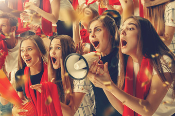 Group of happy fans are cheering for their team victory.