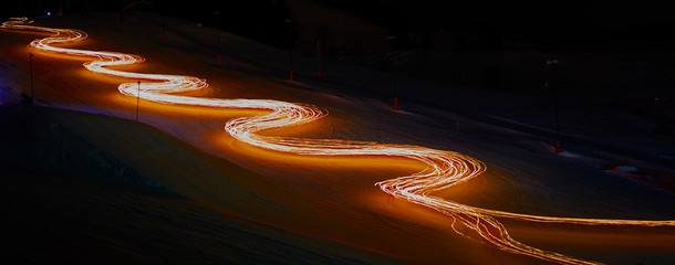 A light trace made by skiers holding torches