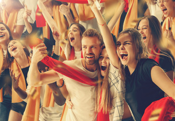 Group of happy fans are cheering for their team victory.
