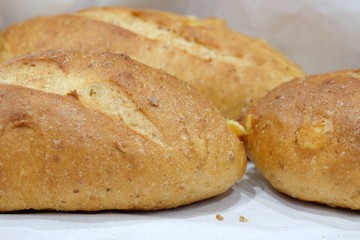 Close up a homemade bread on a white paper in a basket tray