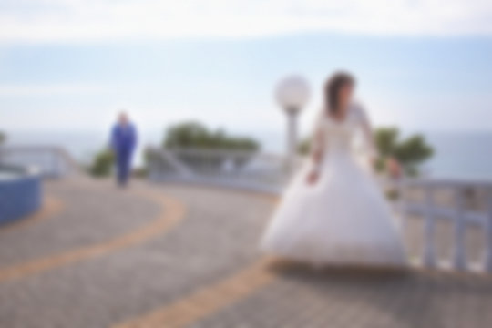 Blurred image background wedding theme on the beach, embankment young couple.