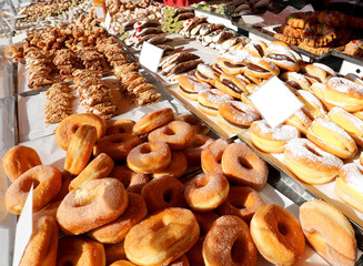 many fried doughnut and more pastries with sugar for sale at kio
