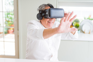 Man wearing virtual reality glasses smiling looking very happy and excited