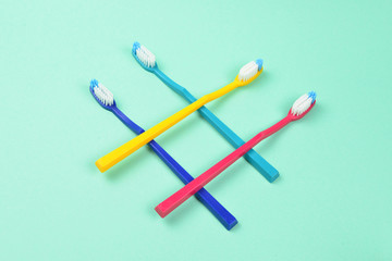 Toothbrushes on a green background. Space for text or design.