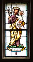 Saint Joseph holding baby Jesus, stained glass window in the parish church of the Holy Trinity in...