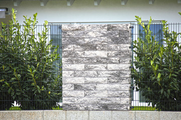 Bright natural stone wall as a property line