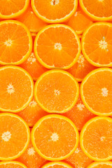 Slices of oranges as a background, top view.