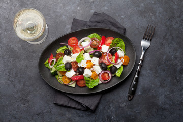 Greek salad plate and white wine