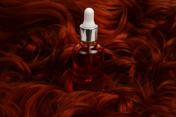 Oil hair treatment for woman with red hair. Spa, beauty salon. Hair care in modern spa salon.