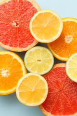 Closeup of sliced citrus fruits colorful background