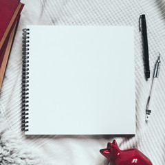 Top view of artistic cozy workplace: opened sketchbook, pen, pencil