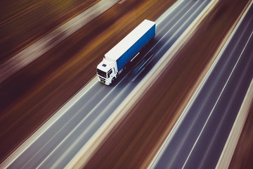Obraz na płótnie Canvas White blue truck speed transport goods highway street motorway