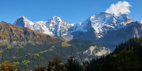 Panoramic mountain view of Jungfrau, Monch, Eiger at sunset in Switzerland.