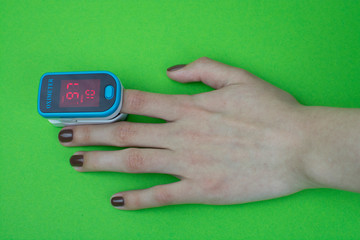 pulse oximeter hand green  background